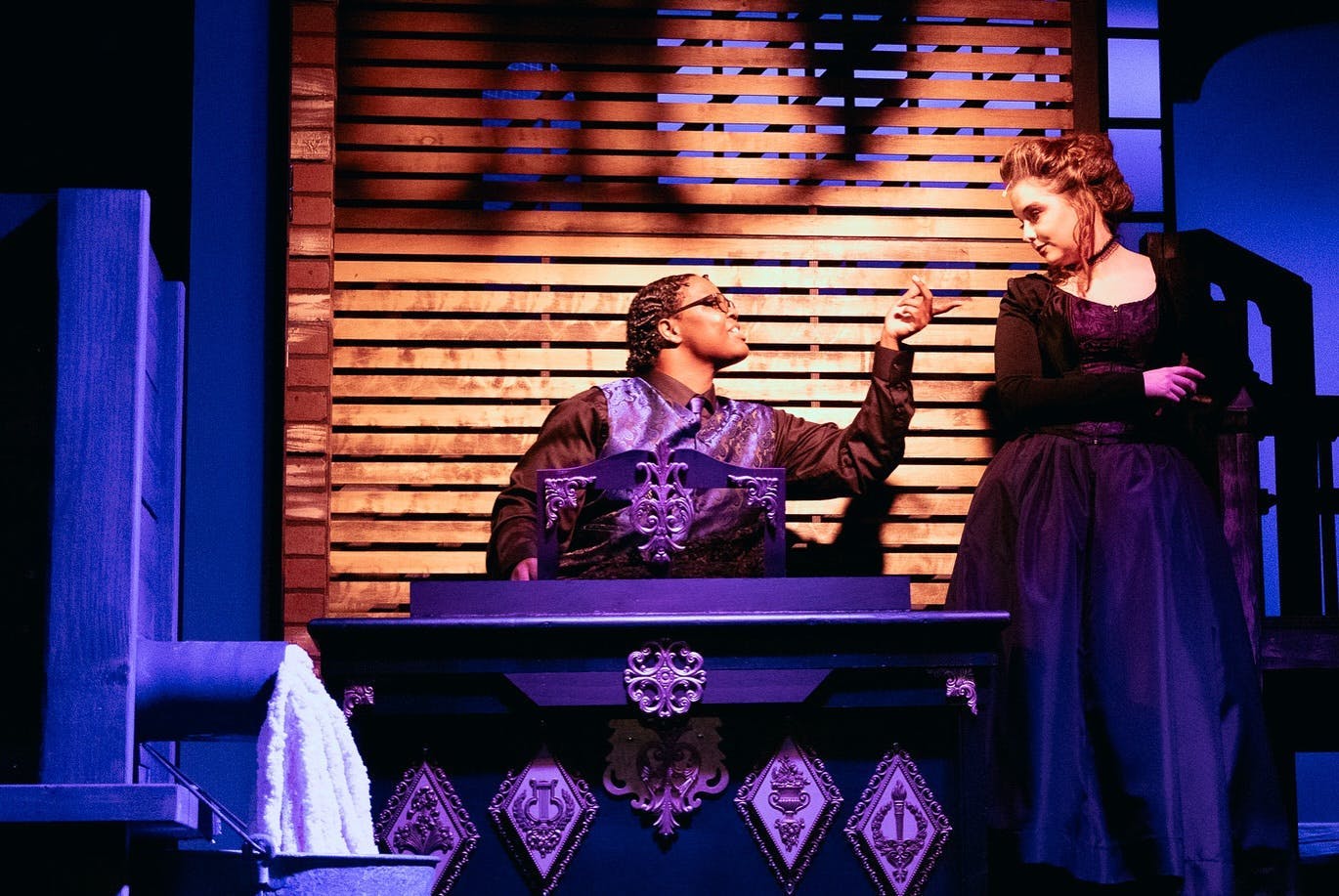 Production of Sweeney Todd featuring the Beadle playing a piano serenading Ms. Lovett	